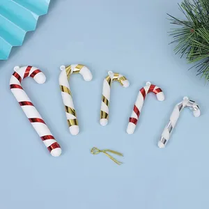 Detailed view of plastic Christmas candy cane ornaments in festive red, gold, and silver colors