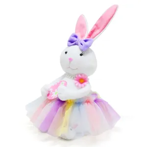 Close-up detail view of a plush Easter bunny wearing a colorful rainbow tutu skirt and purple bow.