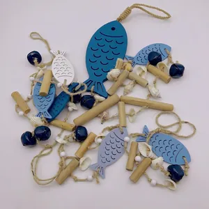 Detailed view of Mediterranean wooden fish hanging decor with bells and shells