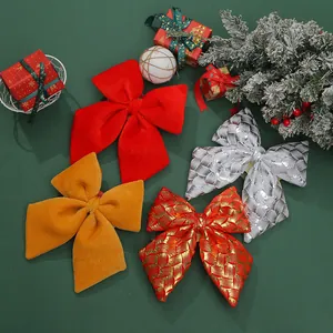 Detailed view of large velvet and patterned Christmas bow ornaments for tree decor