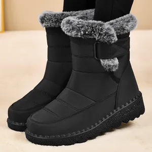 Detail of women's black waterproof snow boots with grey faux fur trim and velcro strap