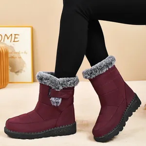 Detail view of burgundy waterproof snow boots with plush faux fur trim and velcro strap