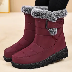 Detailed view of wine-red snow boots with grey faux fur collar and velcro strap