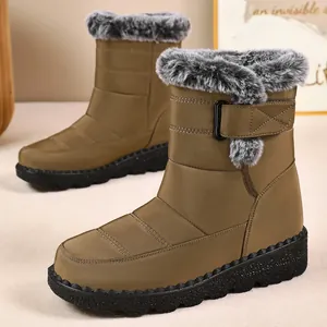 Detailed side view of khaki winter snow boots featuring grey faux fur trim and velcro strap