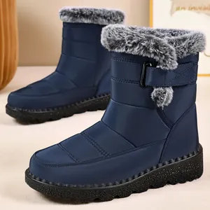 Navy blue waterproof women's snow boots featuring thick grey faux fur lining and velcro strap