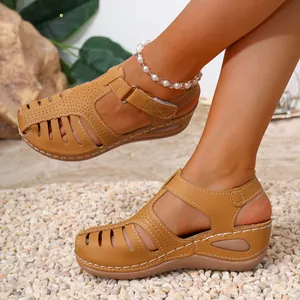 Stylish women's tan wedge platform sandals featuring a hollow-out closed toe design
