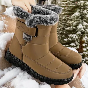 Women's waterproof snow boots with faux fur lining and velcro strap in a snowy scene