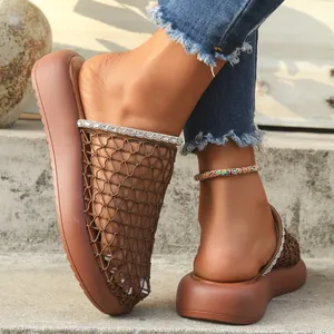 Close-up of brown mesh slide sandals with rhinestone chain trim and thick soles