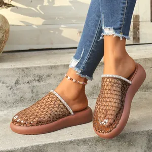Detailed shot of brown mesh clogs with sparkling rhinestone trim and thick soles