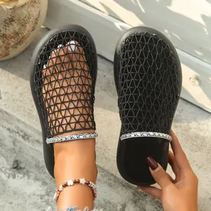 Close-up detail of the breathable mesh upper and sparkly rhinestone chain on these black slides