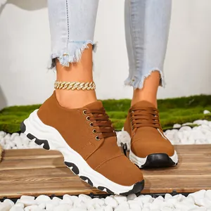Brown platform lace-up sneakers with a thick white sole and suede-like finish