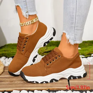 Detailed view of brown platform canvas sneakers featuring 5cm chunky sole on model