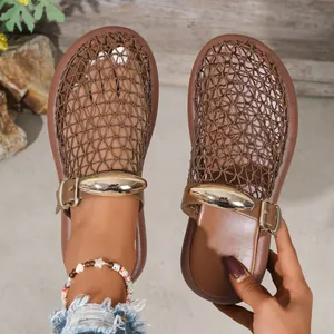 Detail view of breathable brown mesh mule sandals with metallic buckle accents.