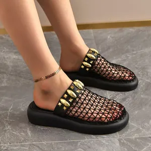 Close-up detail of black mesh slippers with gold stud accents for breathable summer fashion