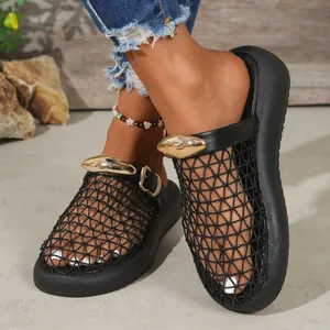 Detailed macro view of black mesh breathable closed-toe sandals with gold hardware.