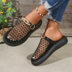 Close-up of women's black mesh breathable mules with elegant gold metal ornament detail