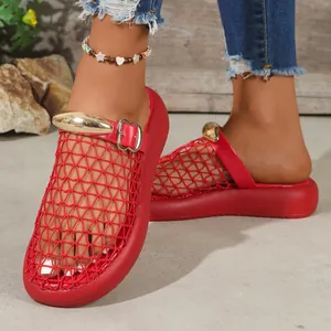 Close-up of red mesh hollow-out sandals featuring a gold metal buckle detail.