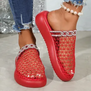 Close-up of red mesh breathable sandals with luxury rhinestone chain design decoration