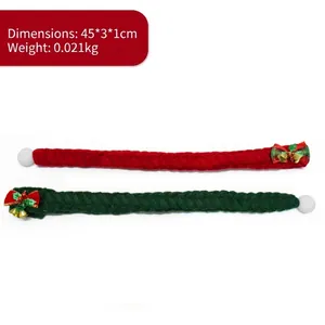 Detail of festive red and green knitted pet scarves with Christmas bells and pom-poms