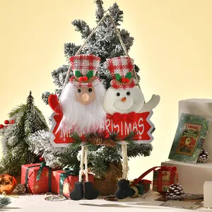 Detail view of plush Santa and Snowman hanging ornament with red Merry Christmas sign board