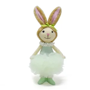 Detail showing a sweet Easter plush bunny doll wearing a light green tutu dress.