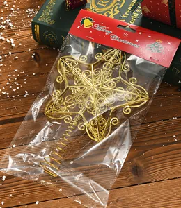 Close-up view of golden hollow five-pointed star Christmas tree topper in holiday packaging