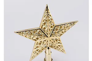 Macro view of the intricate golden hollowed-out pentagram Christmas tree topper star
