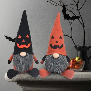 Detail of Halloween plush gnomes featuring pumpkin face hats in a festive setting