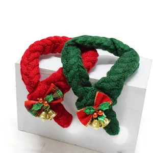 Detailed view of red and green knitted Christmas pet collars with festive golden bells