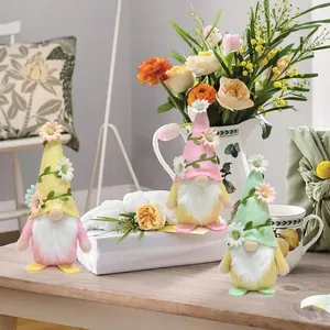 Three colorful faceless spring gnomes dolls with flower hats for table decoration