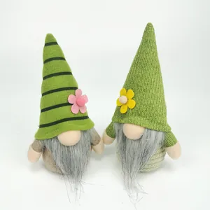 Detail showing two handmade St. Patrick's Day green plush gnomes with cute flower accents
