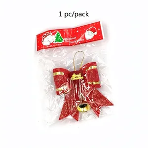 Detailed view of a red 3D Christmas bow in clear retail packaging