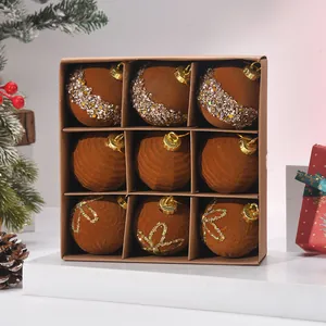 Set of 9 brown flocked Christmas ornaments with sequins and glitter in a gift box.
