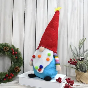 Close-up of a festive Christmas gnome doll with colorful pom-poms and a tall red hat.