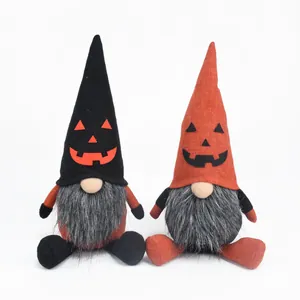 Detailed shot of two Halloween faceless gnomes featuring pumpkin face embroidery and faux fur