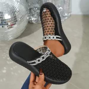 Close-up detail of black breathable mesh mules featuring a stylish rhinestone chain