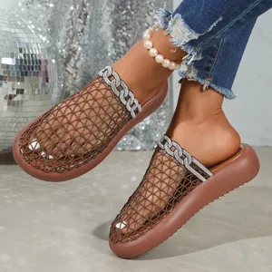 Close-up of breathable brown mesh mules featuring elegant rhinestone chain decoration.