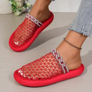 Close-up detail of red mesh slippers featuring rhinestone chain and breathable upper