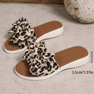 Close-up detail showing the 3.5cm platform sole height on leopard print bow sliders.