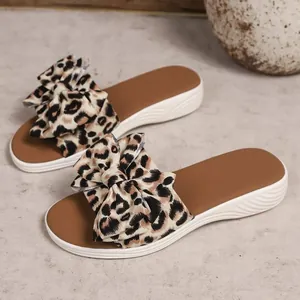 Stylish leopard print bow flat slide sandals for women comfortable summer beach wear.