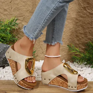 Detail view of women's peep-toe wedge sandals with golden buckle and cork platform