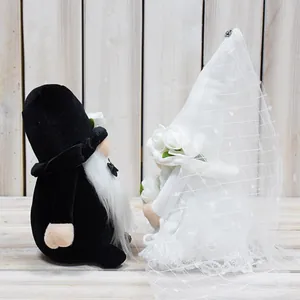 Detailed close-up view of handmade wedding gnome couple dressed in bride and groom outfits