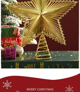 Close-up of a gold-plated hollow star topper on a Christmas tree with festive gifts.