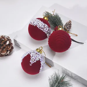 Macro detail of red flocked Christmas ornaments with white sequins on a white base