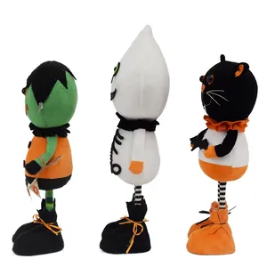Side view of three standing Halloween plush dolls: Frankenstein, Ghost, and Black Cat