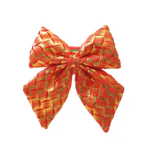 Detailed close-up view of a festive red and gold textured Christmas bow tree ornament.