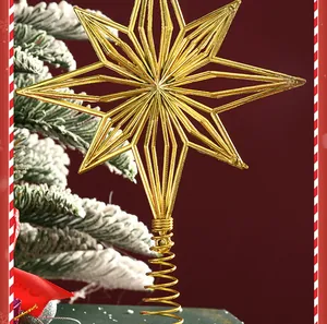 Detailed view of a gold plated hollow Christmas tree topper star with spring base.