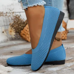 Detailed macro view of blue knitted mesh loafers with breathable cutout pattern design