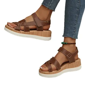 Stylish women's brown wedge platform sandals with strap design on white background