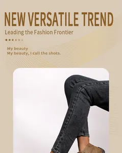 Detailed shot of hand-stitched tan casual loafers worn with dark grey denim skinny jeans